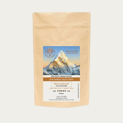 Kraft paper coffee bag with mountain graphic and brand logo on a white background